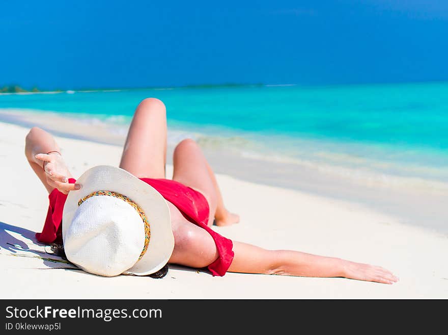 Young Beautiful Girl Lying On Snow White Tropical Beach