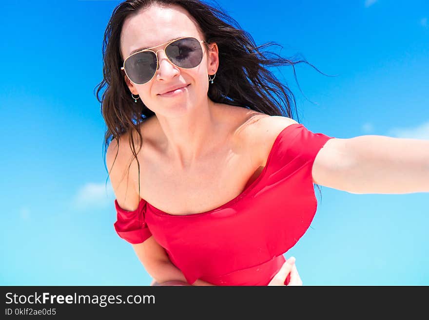 Young happy woman in swimsuit on white beach. Young happy woman in swimsuit on white beach