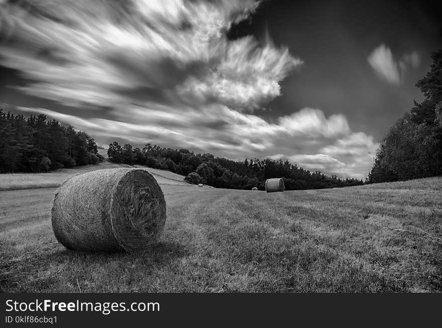 Race of clouds on meadow with parcel