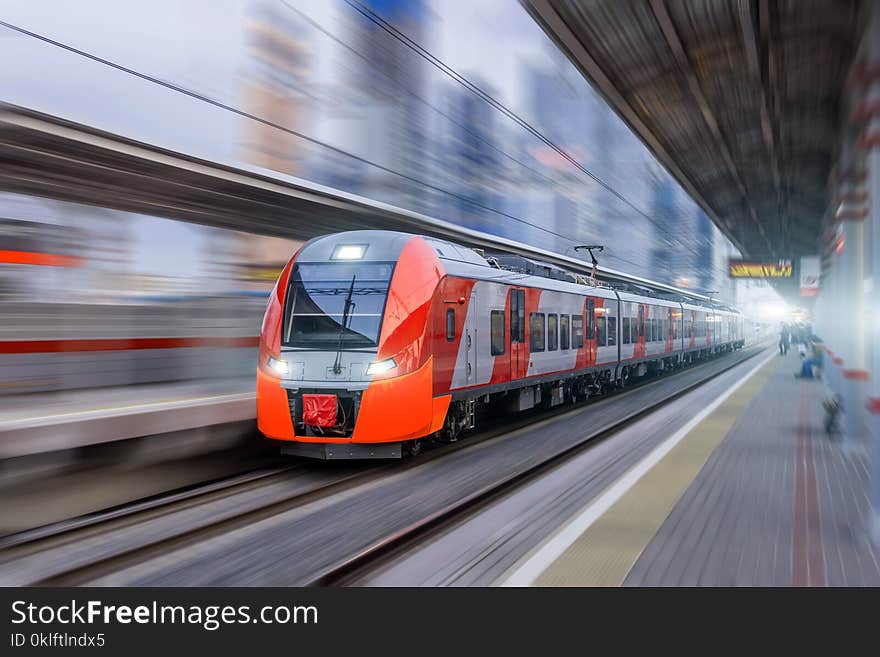 High speed train rides at high speed at the railway station in the city.