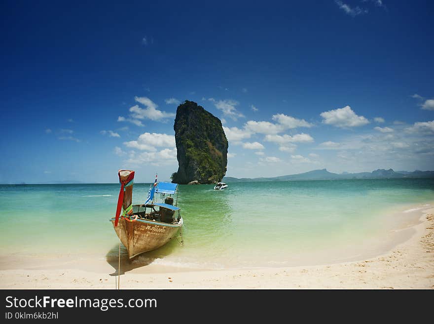 Brown on Seashore Near Mountain