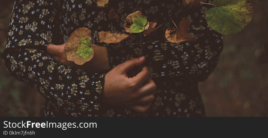 Photo of Person Wearing Black and White Floral Long-sleeved Shirt With Leaves All over in Top