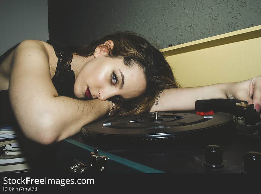 Woman Wearing Black Top Lying on Turntable