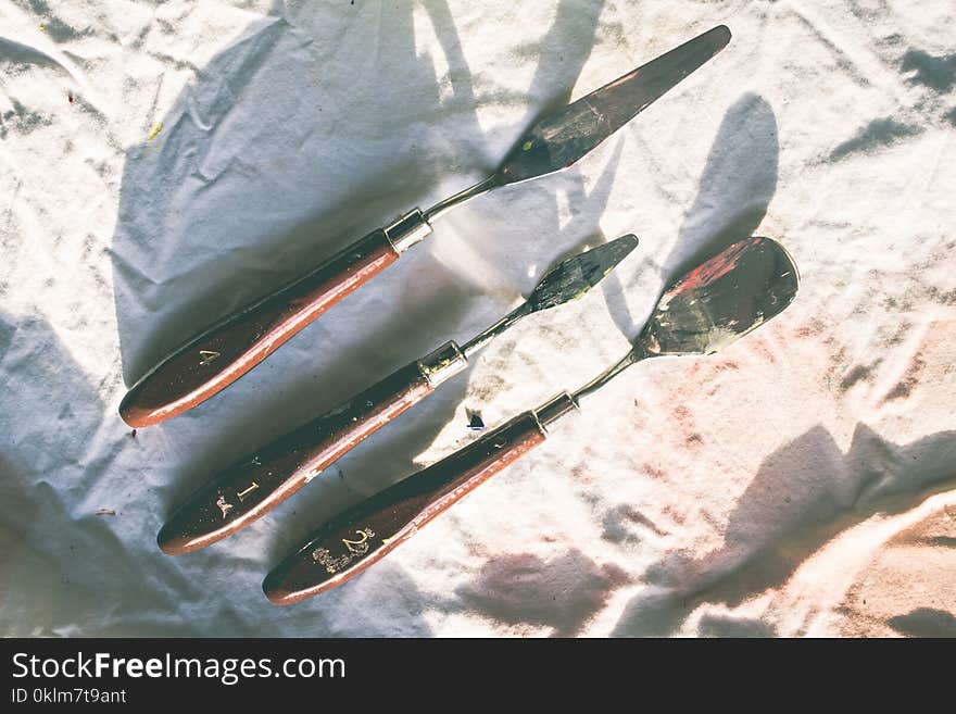 Three Brown Wooden Handled Tools