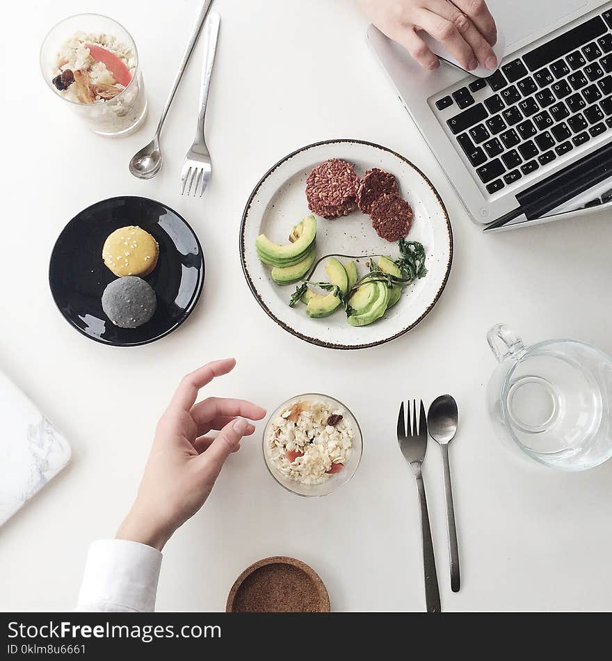 Photo of White Plate Beside Macbook