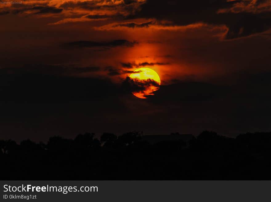 Orange Sun Hiding on Clouds