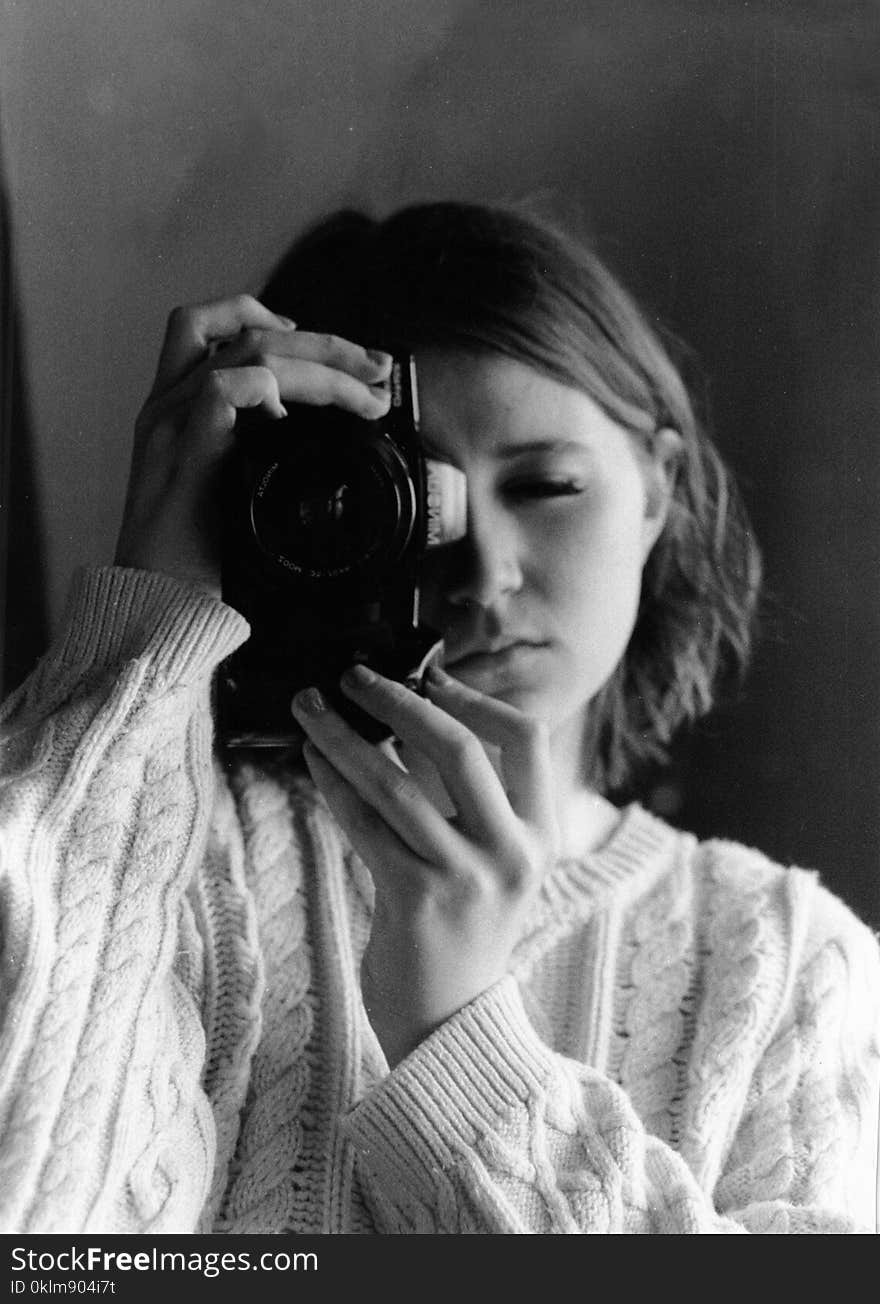 Grayscale Photography of Woman Holding Camera