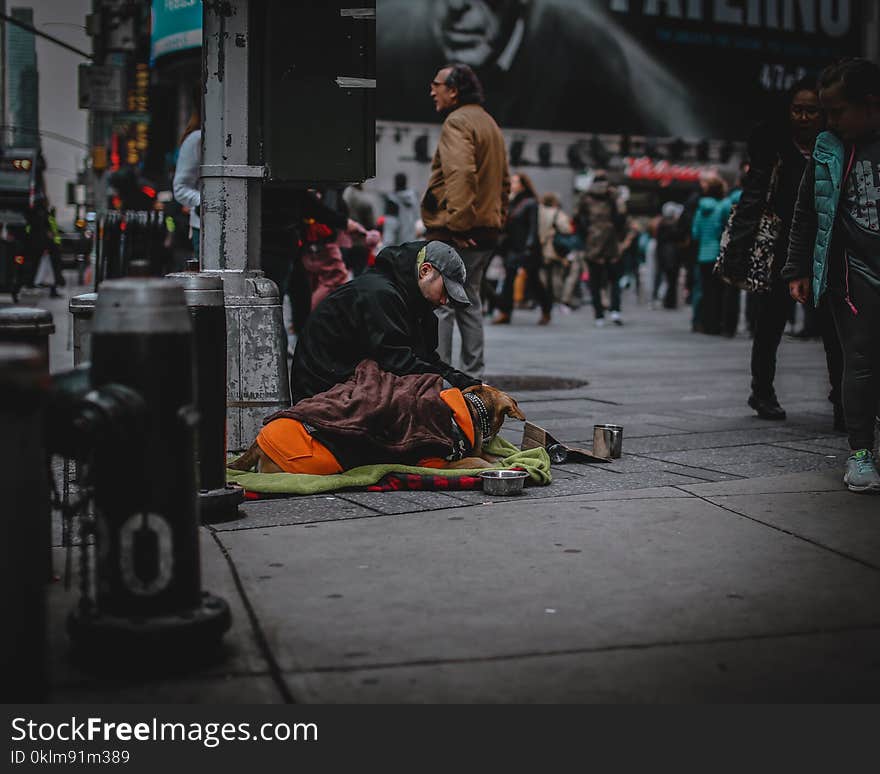 Man Siting on a Concrete Pavement