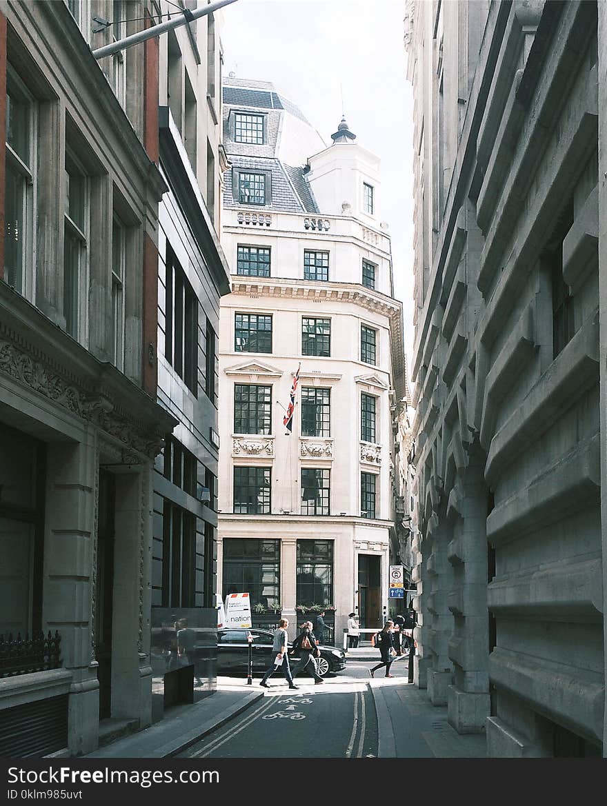 People Walking Near Building and Cars