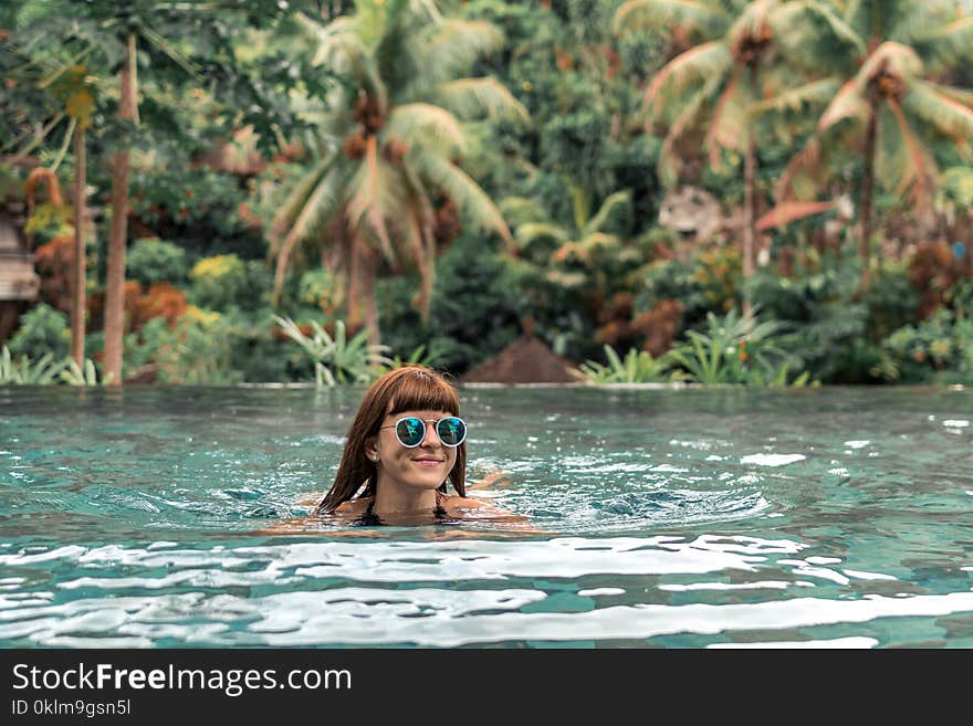 Woman Swimming Wearing Green Sunglasses