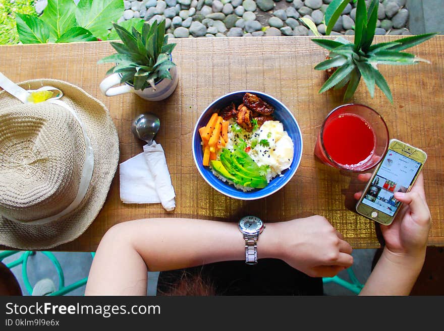 Woman Holding Iphone While Eating