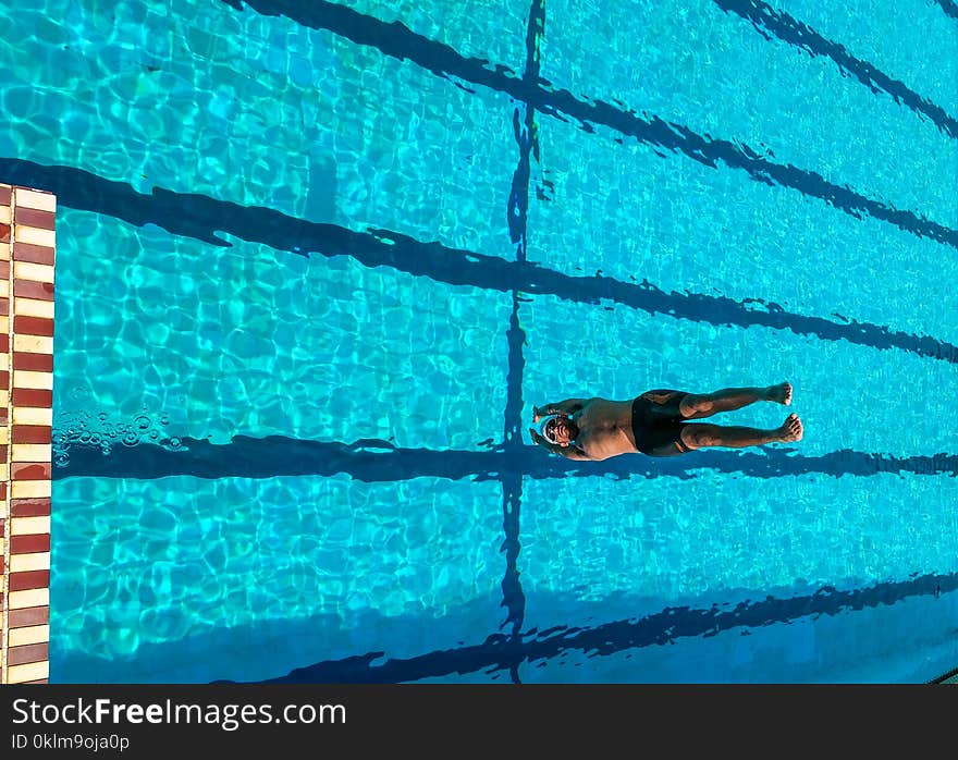 Person Diving on Swimming Pool