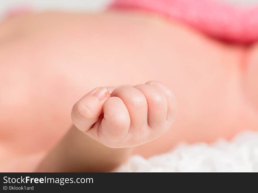 Closeup portrait little baby hands background on the bed. Closeup portrait little baby hands background on the bed