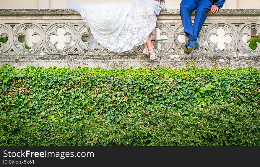 Portrait bride and groom legs, close up your shoes and dress