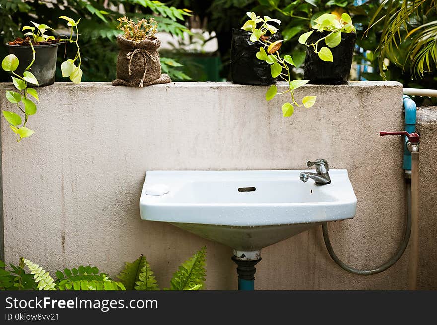 Vintage Of Washbasin And Grunge Wall In The Garden