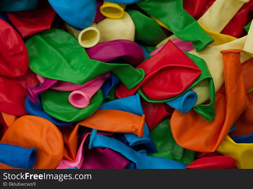 Colorful balloons and confetti on blue table top view. Festive or party background. Flat lay style. Copy space for text. Birthday greeting card.Selective focus