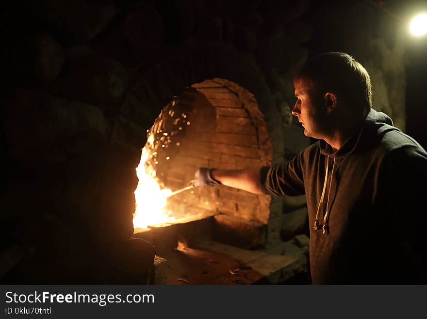 Man preparing fire in stove for grilling food