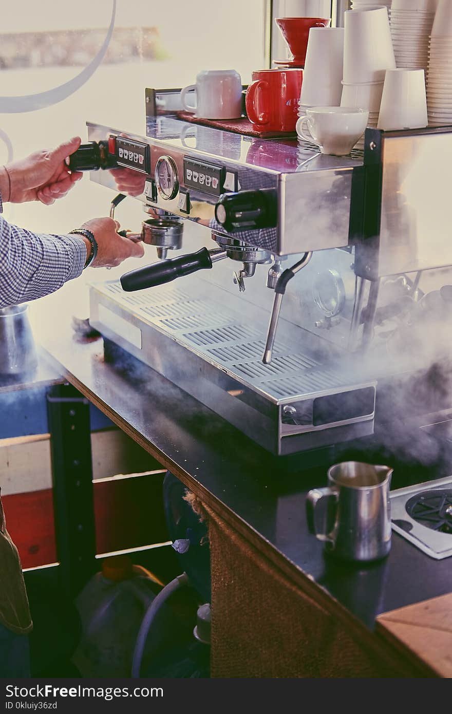 Close up image of a man preparing late in a coffee machine. Close up image of a man preparing late in a coffee machine.