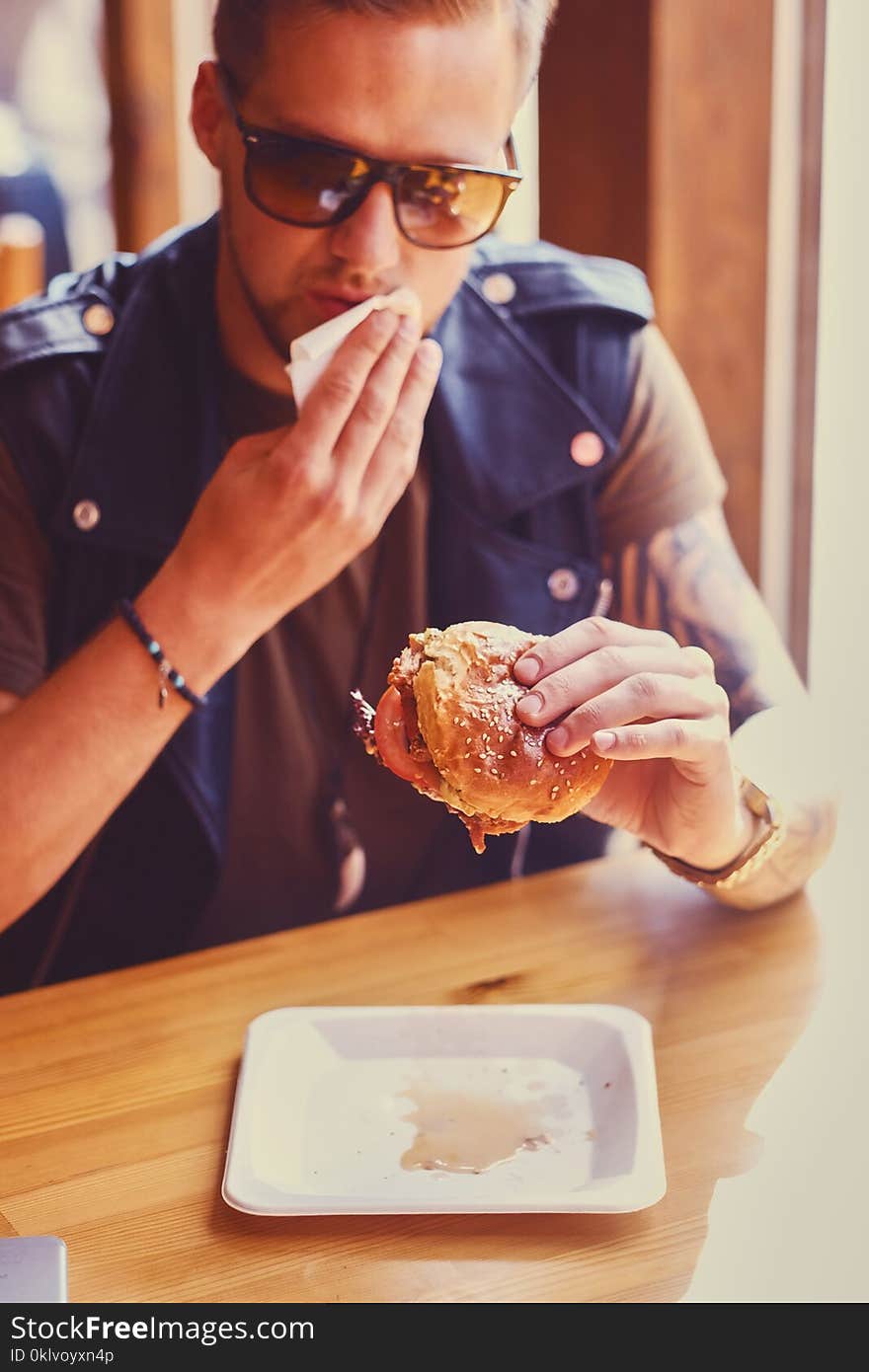 A man eating a vegan burger.