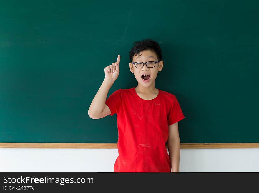 Asian student boy thinking answer for question in class room at school. Asian student boy thinking answer for question in class room at school