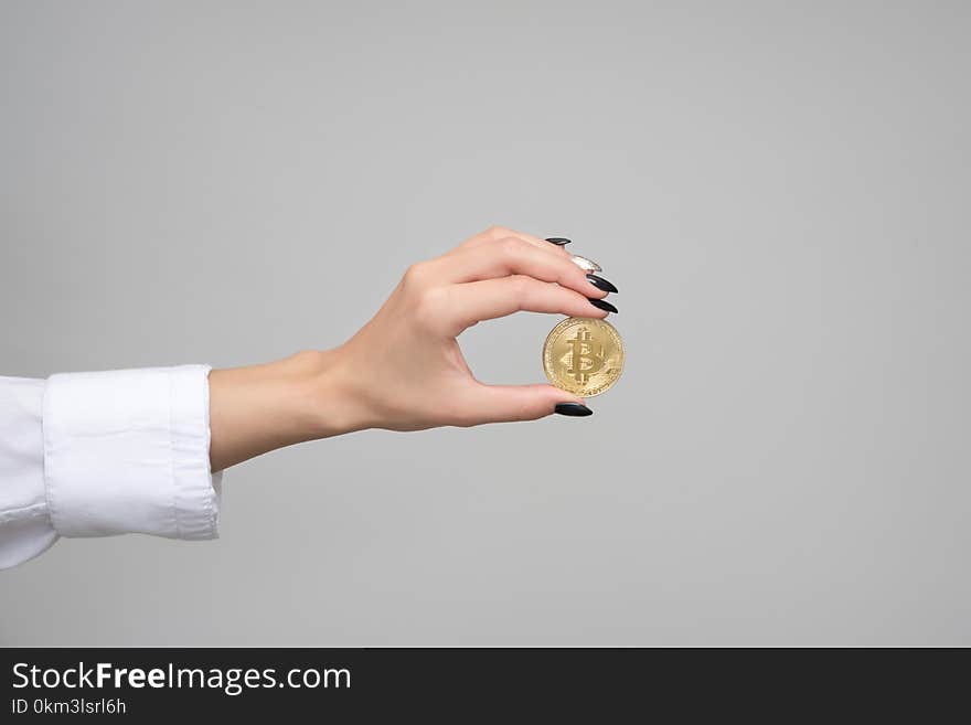 Woman Holding a Bitcoin