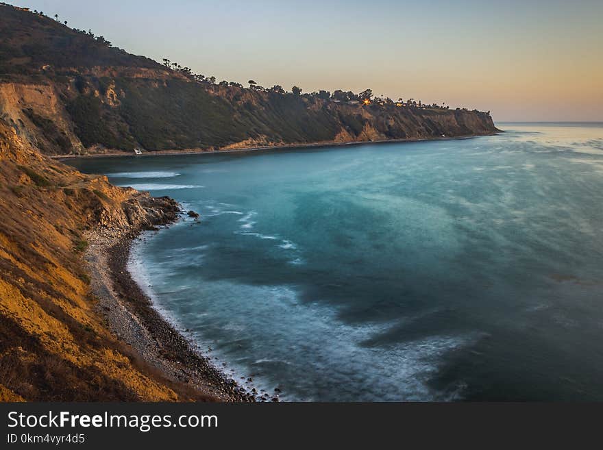 Long-exposure elevated view of Bluff Clove with waves crashing onto the shore at sunset, Palos Verdes Estates, California. Long-exposure elevated view of Bluff Clove with waves crashing onto the shore at sunset, Palos Verdes Estates, California