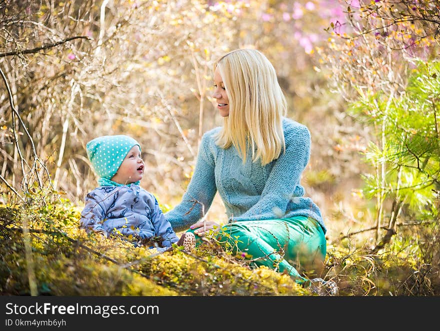 Happy women and baby girl in the blooming spring forest. Happy women and baby girl in the blooming spring forest