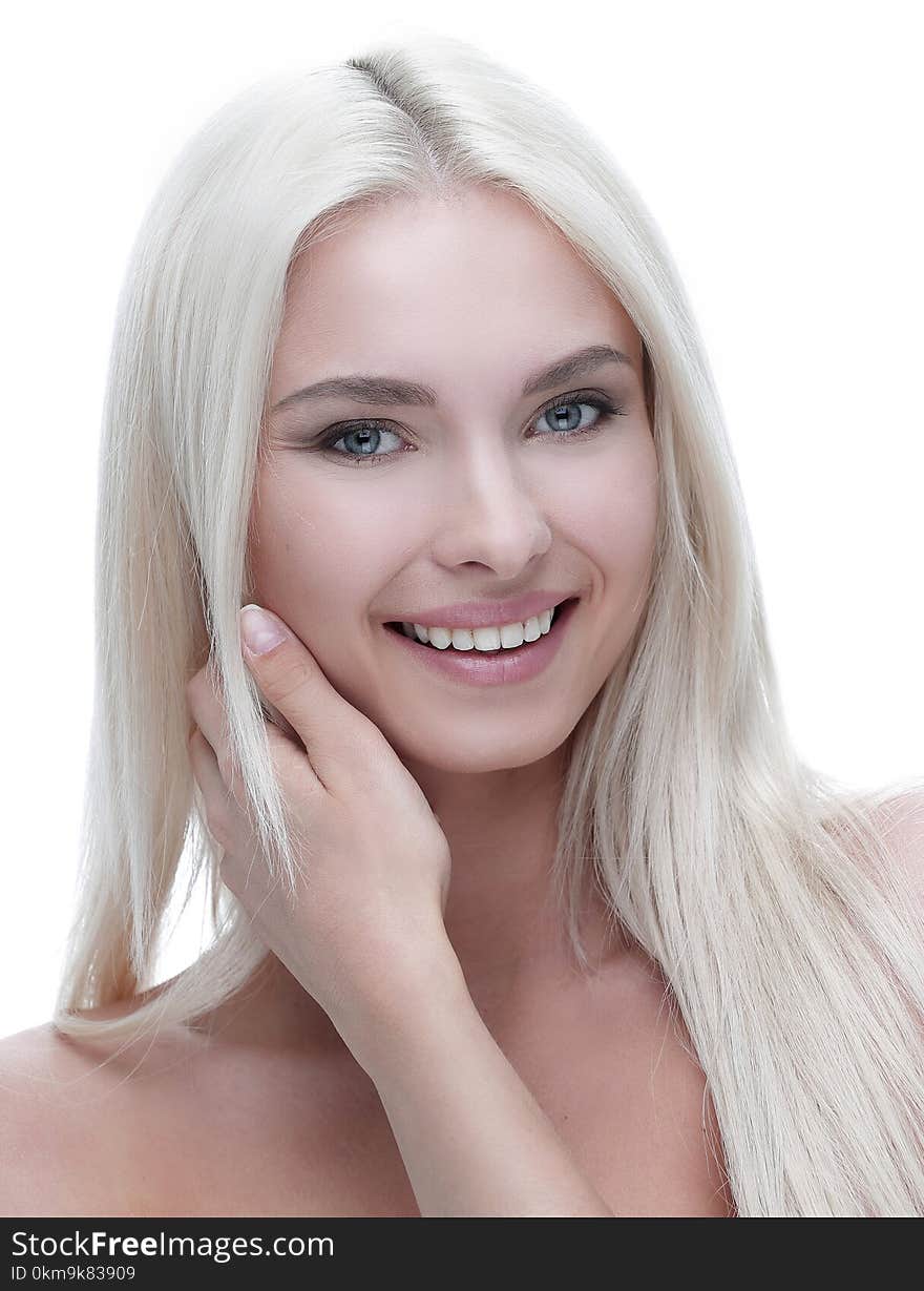 Close-up of a beautiful woman with blond hair touching her face with hands