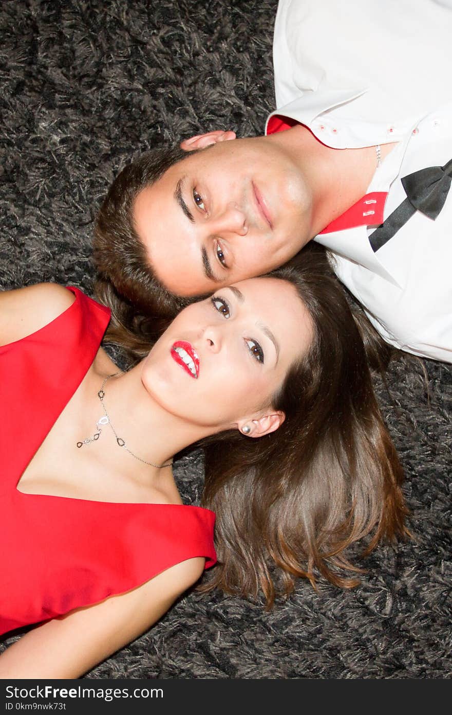 Beautiful couple lying on floor carpet in love