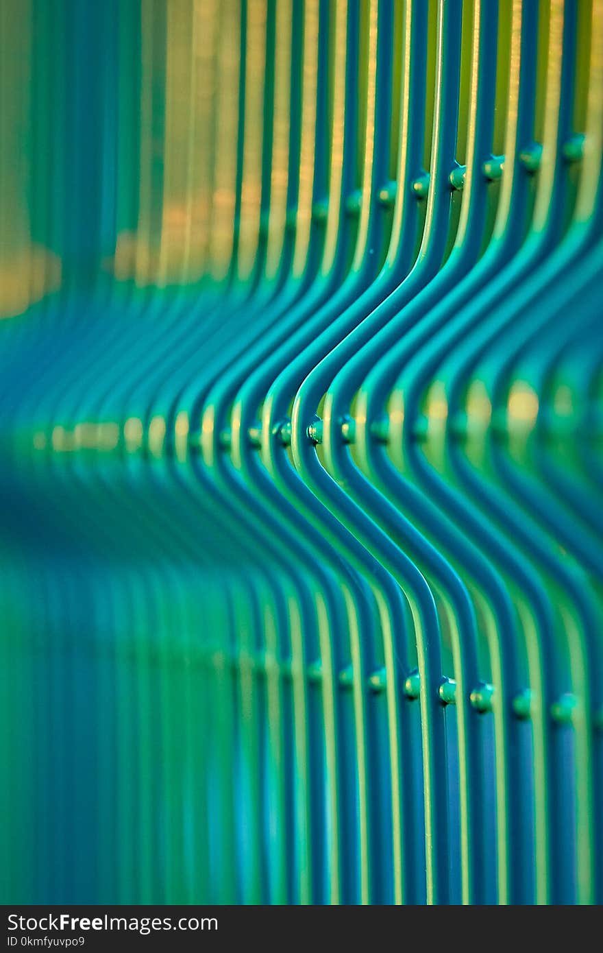 Green wavy mesh fence close up. Can be used as a background.