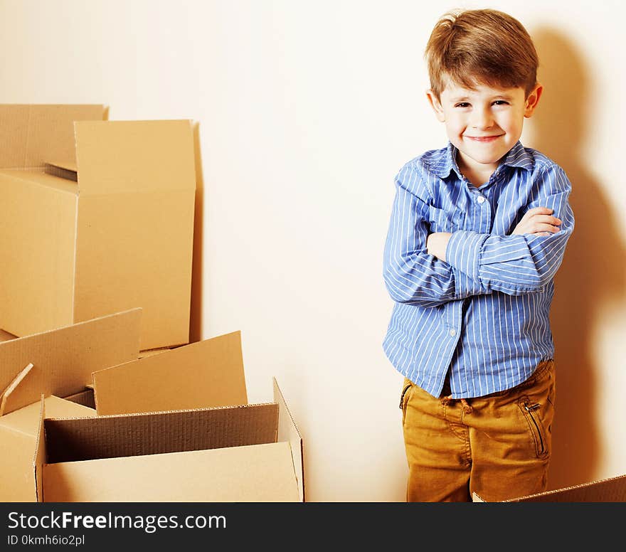 Little cute boy in empty room, remoove to new house. home alone, lifestyle people concept close up