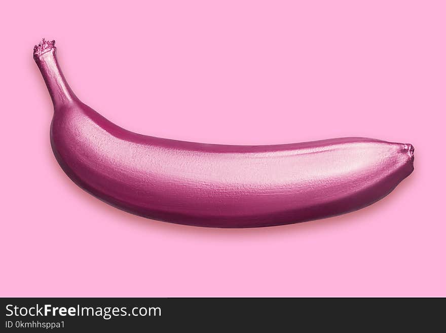 Purple metallic banana on a pink background. A modern creative concept. Contemporary art. Hand-painted fruit