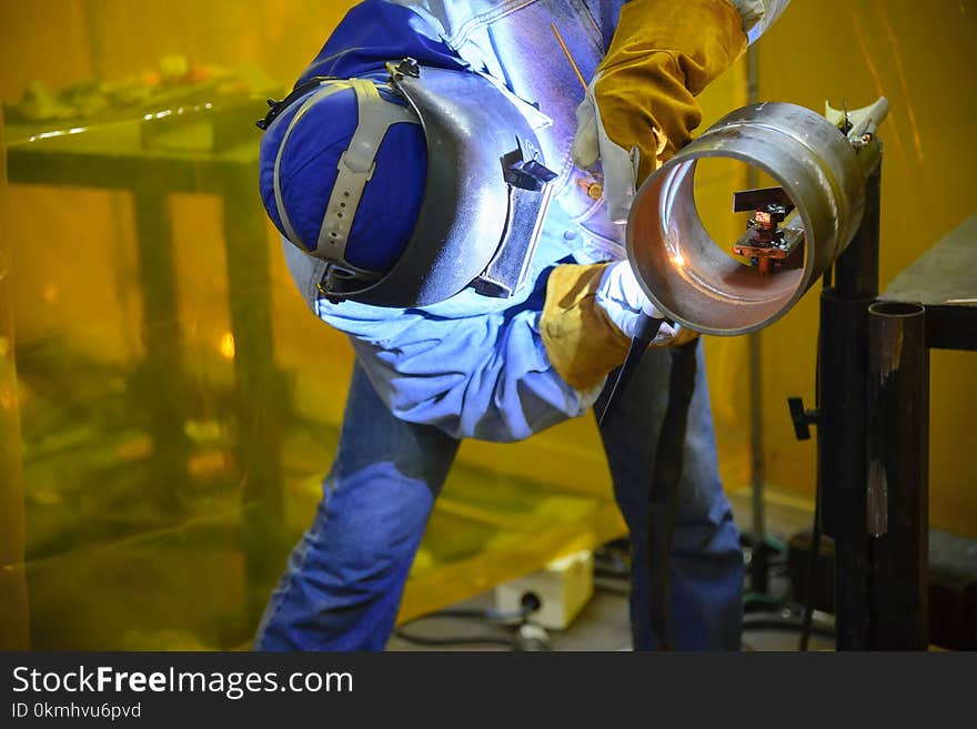 Skill welding operator welding the steel pipe for practice.The construction industrial operator.