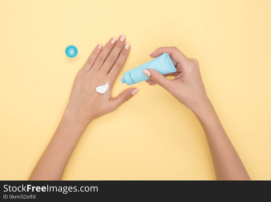 Person Pouring Plastic Tube Bottle