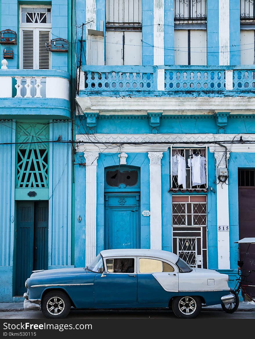 Classic Blue and White Sedan Near Building