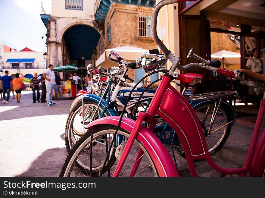 Red Beach Cruiser Bicycle Across Concrete Building