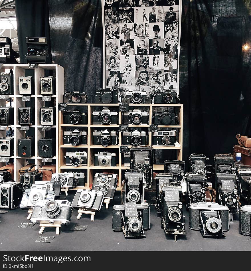 Assorted Cameras on Table and Racks