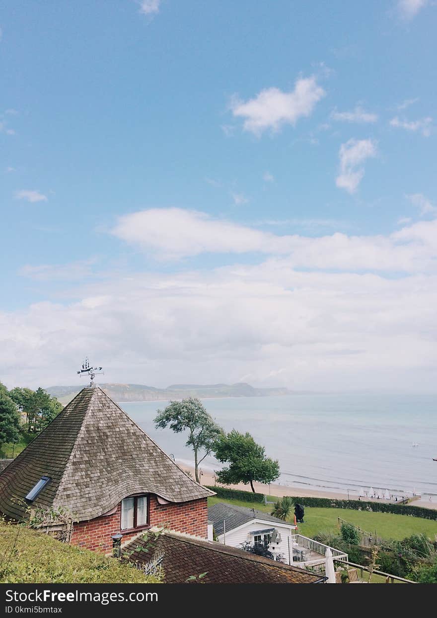 Photo of Brown and Gray Concrete House Near Shore