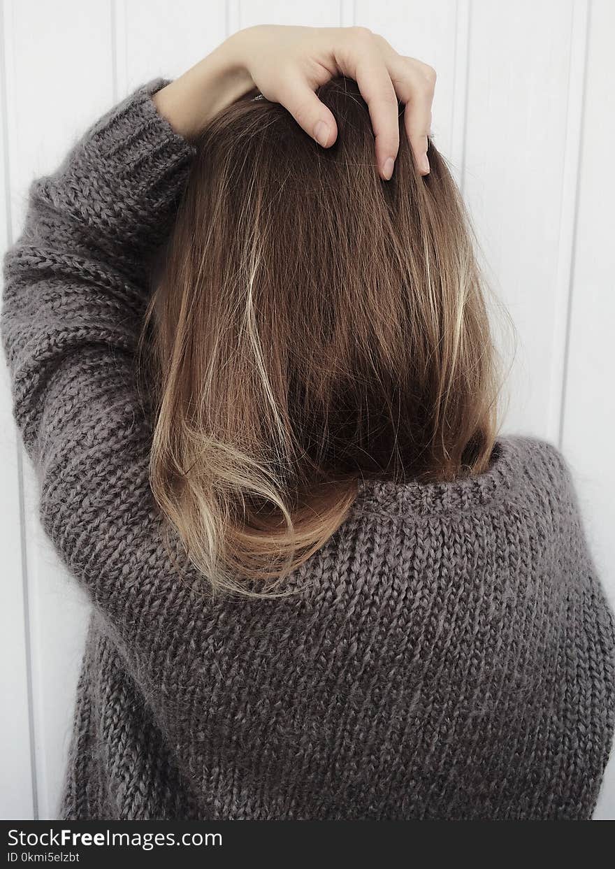 Woman Wearing Black Crew-neck Knitted Long-sleeved Shirt Beside White Wall