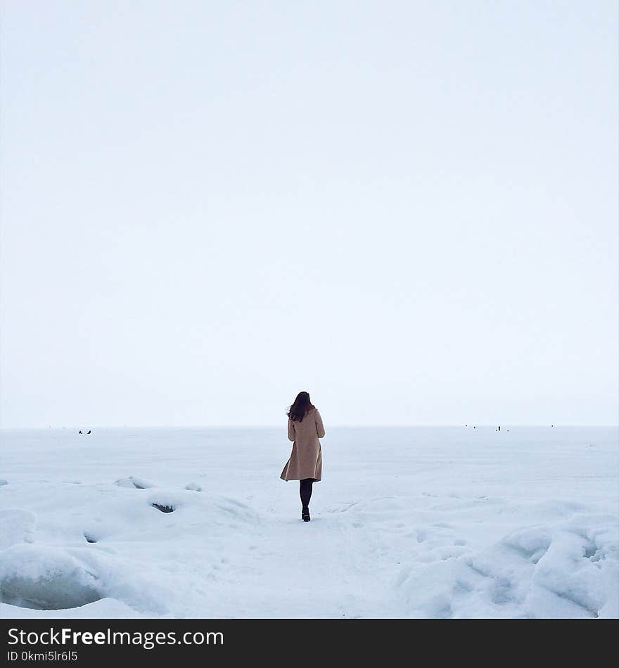 Woman in Brown Coat on Snow