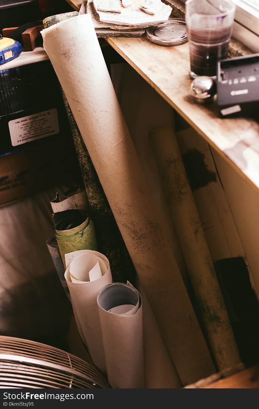 Assorted-color Paper Rolls Beside Wooden Shelf