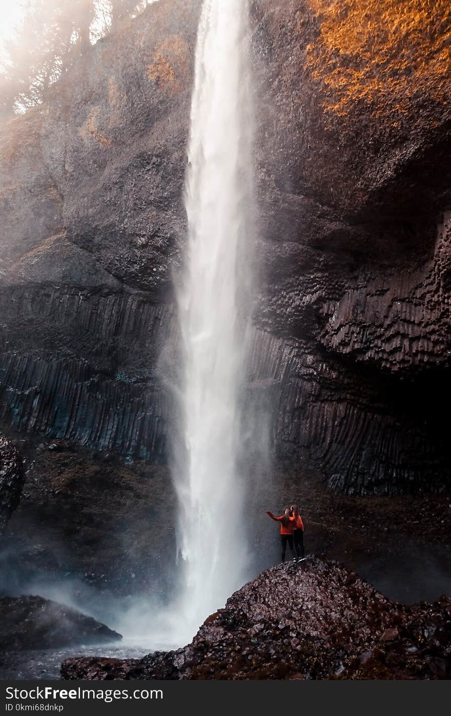 Two Man Beside Waterfall Taken At Daytime