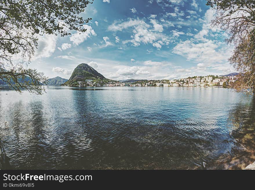 Skyline Photography of Mountain and Buildings at Daytime