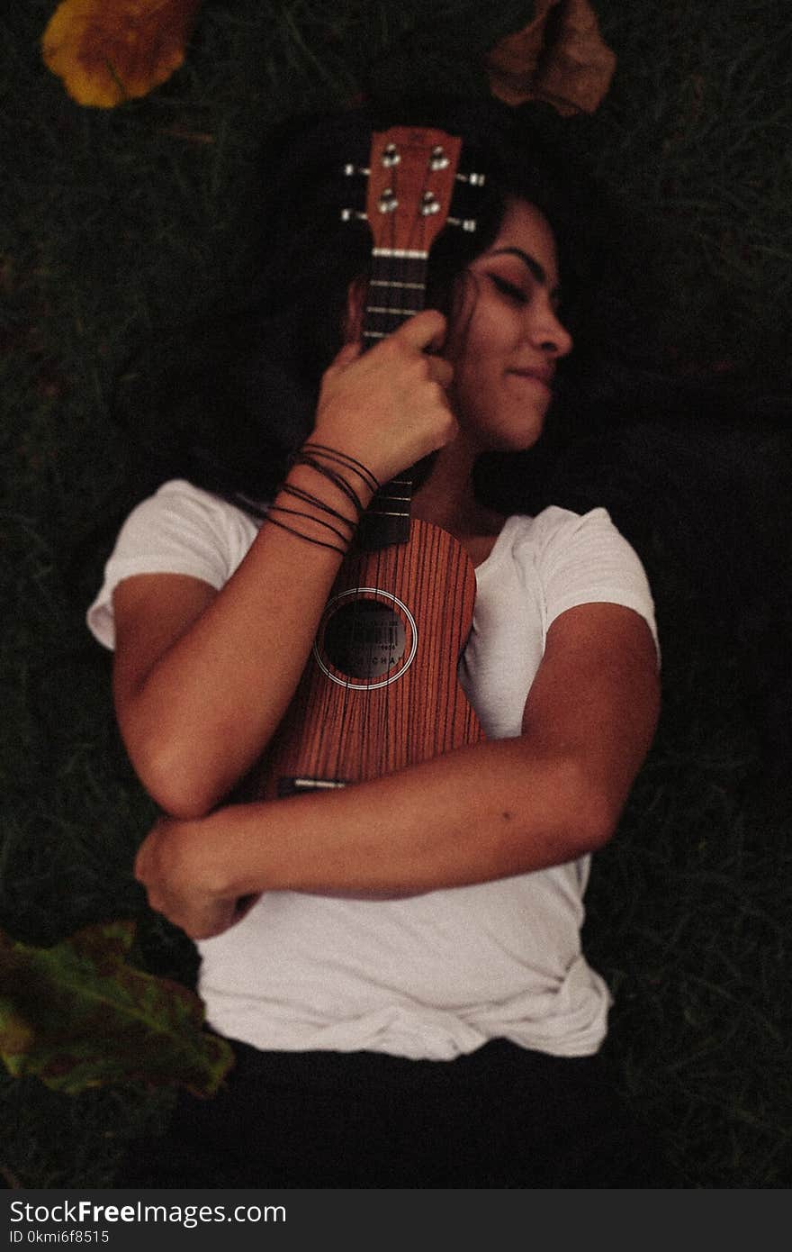 Person Hugging Brown Ukelele