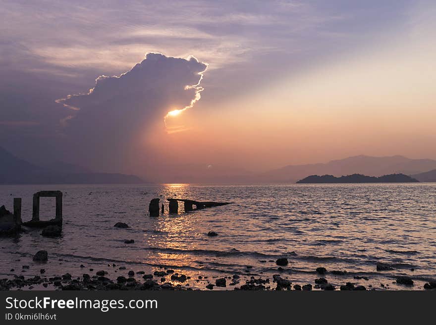 Seashore Under Cloudy Sky in Golden Hour Photography