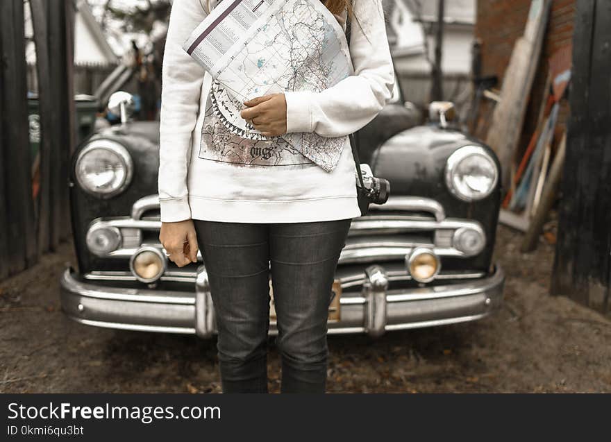 Person Holding Map With Car at the Back