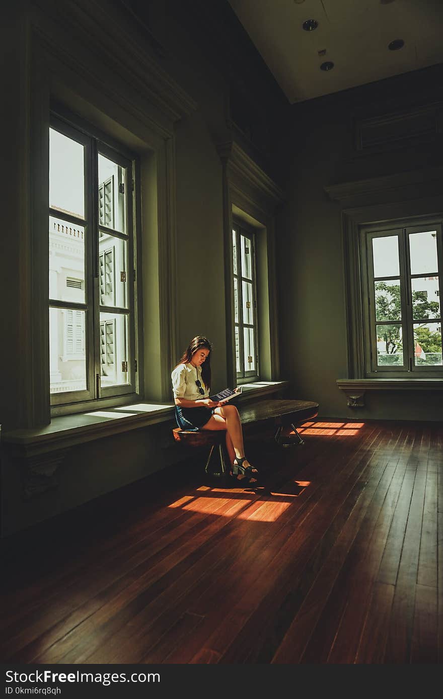 Woman Wearing White Top Sitting Down Near White Wooden 6-lite Window