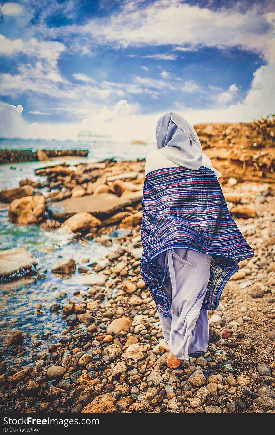 Person Standing on Seashore