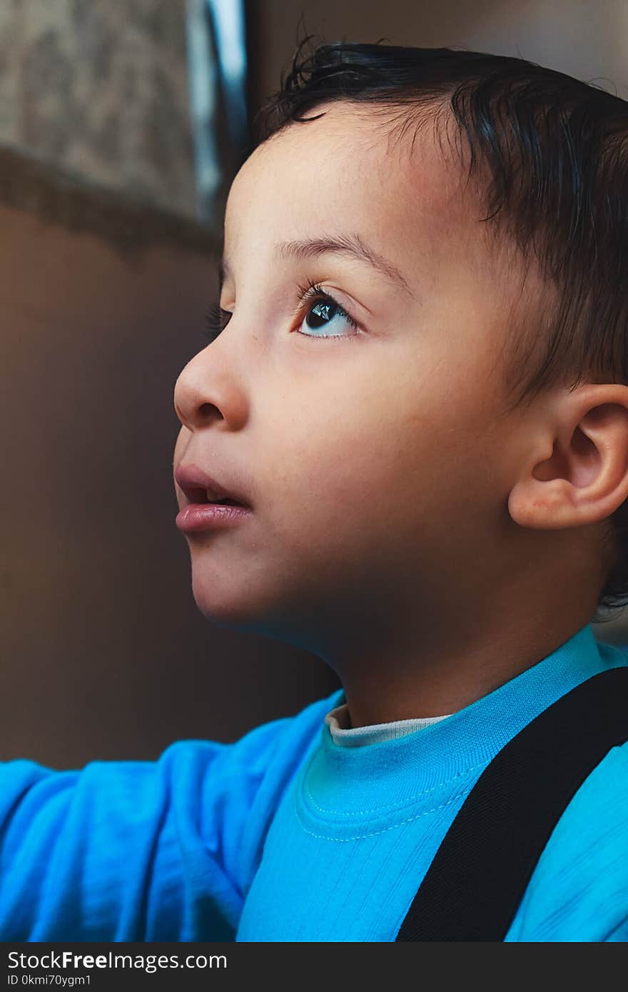 Boy Wearing Blue Top Looking Up