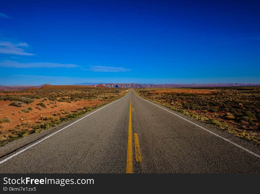 Straight Road Surrounded With Grass